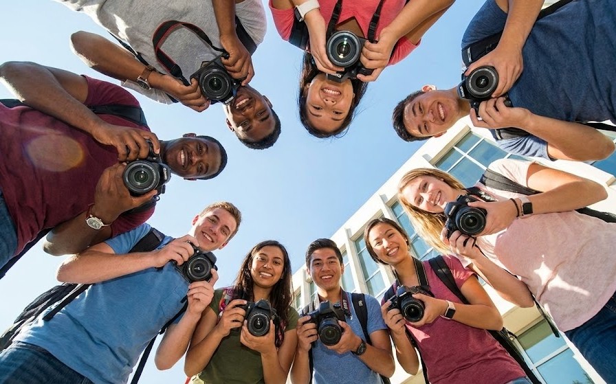 Diverse group of photographers looking at camera